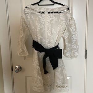 White silk dress with black belt